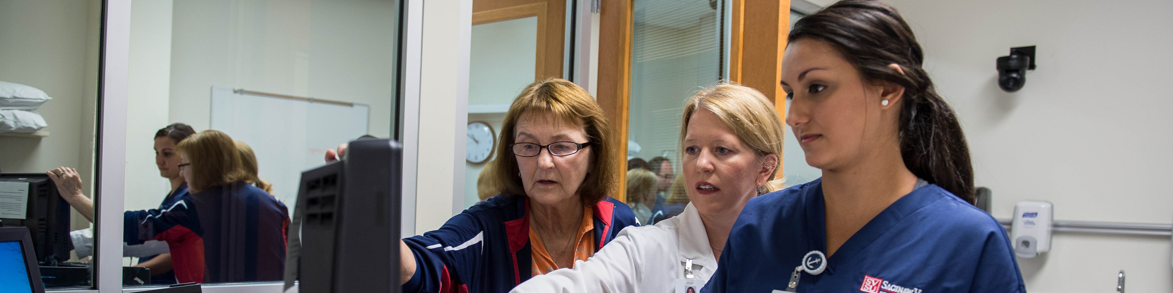 Nursing Staff and Student Working Together